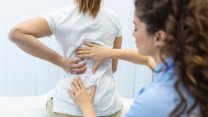 PT checking patient's back pain